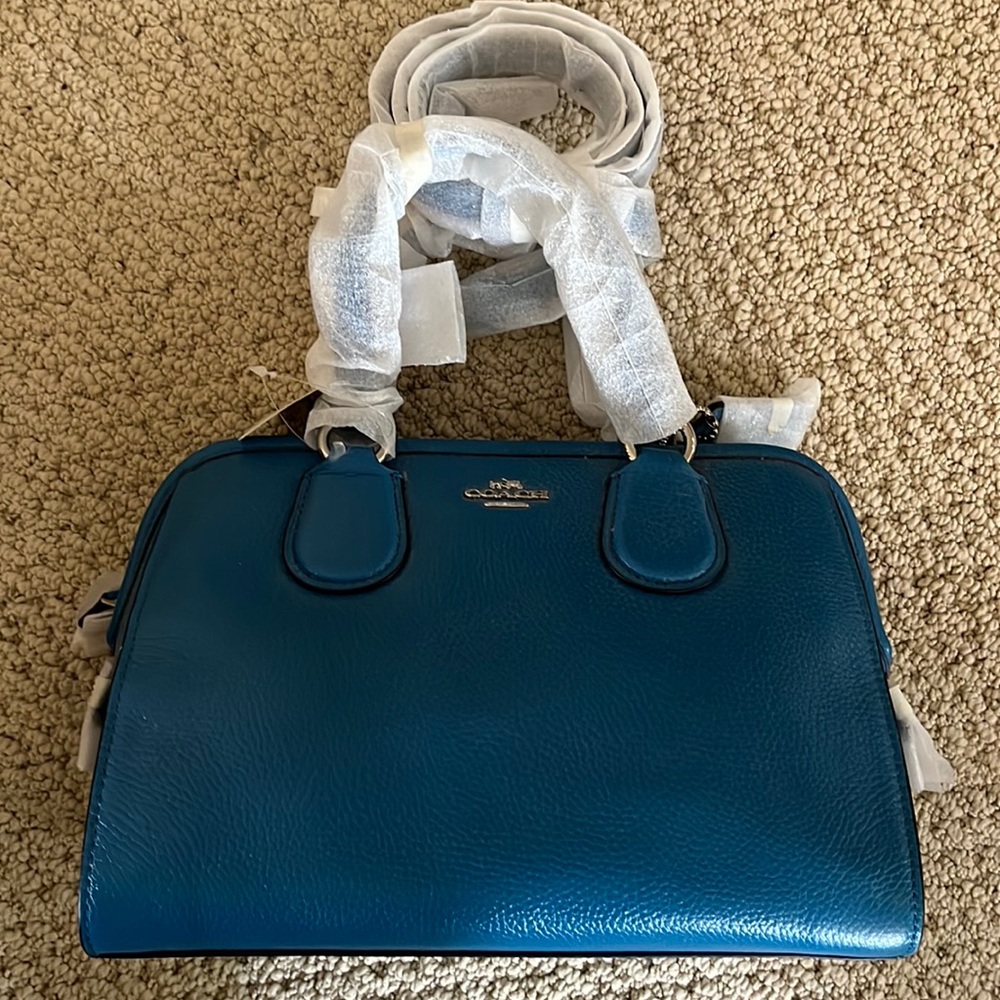 Coach leather purse. Top handle with option to wear cross body with strap.